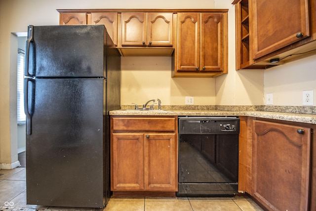 611 N Bradley Ave, Indianapolis, IN 46201 - kitchen with black appliances, light tile patterned flooring, light countertops, and brown cabinets