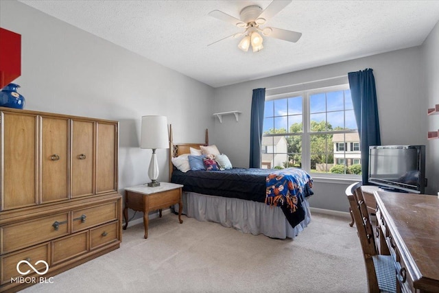 8827 Lindsey Ct, Fishers, IN 46038 - bedroom featuring light carpet, a textured ceiling, and a ceiling fan