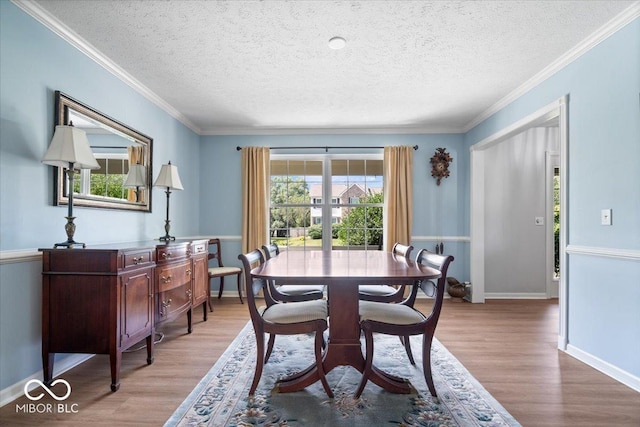 8827 Lindsey Ct, Fishers, IN 46038 - dining room with wood finished floors, a textured ceiling, and crown molding