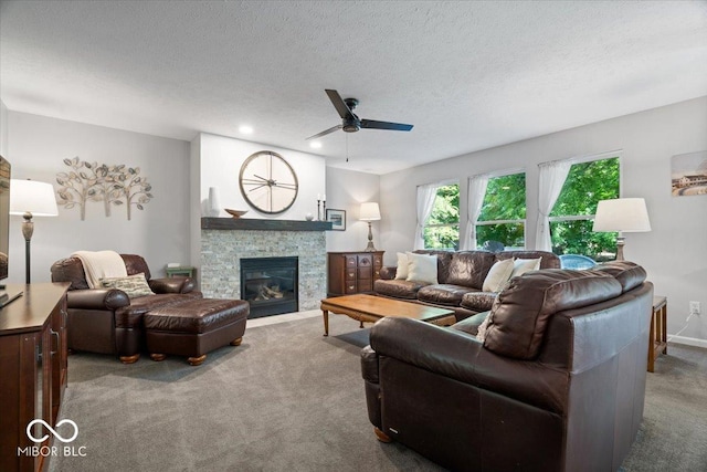 8827 Lindsey Ct, Fishers, IN 46038 - living room featuring carpet, a ceiling fan, a stone fireplace, a textured ceiling, and recessed lighting
