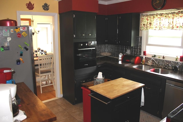 705 Terrace Ln, Greencastle, IN 46135 - kitchen featuring appliances with stainless steel finishes, butcher block counters, dark cabinetry, and decorative backsplash