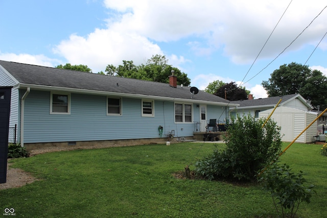 705 Terrace Ln, Greencastle, IN 46135 - back of house featuring a shed, a lawn, a chimney, and a shingled roof