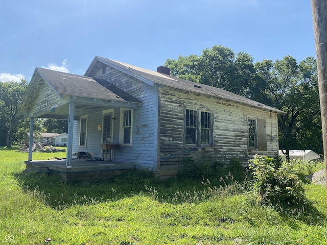 7111 W Tabor Hill Rd, Ellettsville, IN 47429 - view of property exterior with covered porch and a chimney