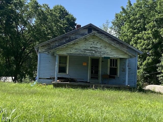 7111 W Tabor Hill Rd, Ellettsville, IN 47429 - bungalow with a porch and a chimney