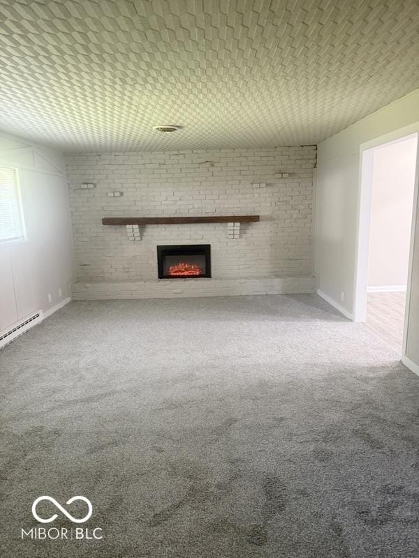 1306 Woodbine Dr, Anderson, IN 46011 - unfurnished living room featuring a brick fireplace, carpet floors, brick wall, and a baseboard heating unit
