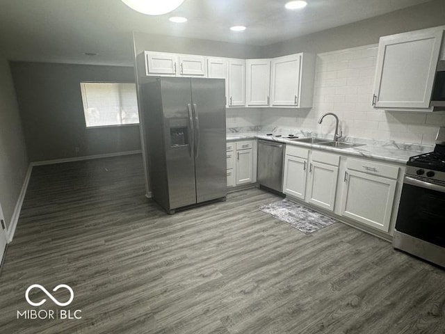 1306 Woodbine Dr, Anderson, IN 46011 - kitchen featuring appliances with stainless steel finishes, light countertops, white cabinets, wood finished floors, and recessed lighting