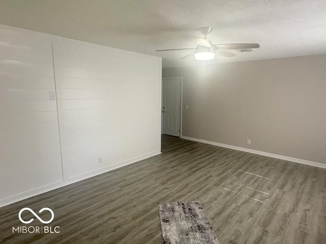 1306 Woodbine Dr, Anderson, IN 46011 - empty room with dark wood-type flooring, a textured ceiling, and ceiling fan