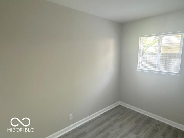 1306 Woodbine Dr, Anderson, IN 46011 - unfurnished room featuring baseboards and dark wood-type flooring