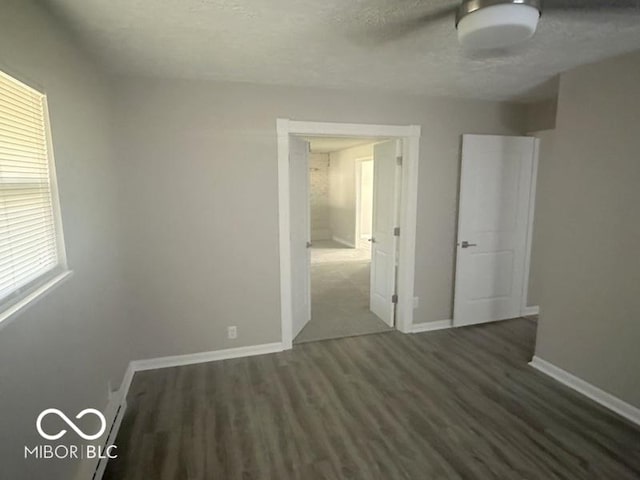 1306 Woodbine Dr, Anderson, IN 46011 - unfurnished bedroom with wood finished floors and a textured ceiling