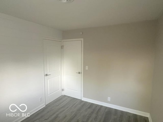 1306 Woodbine Dr, Anderson, IN 46011 - spare room featuring dark wood-style flooring