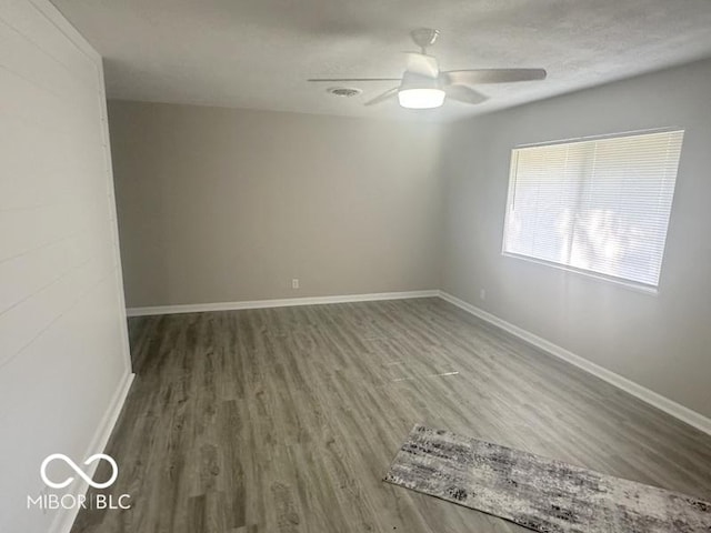 1306 Woodbine Dr, Anderson, IN 46011 - empty room featuring wood finished floors and ceiling fan