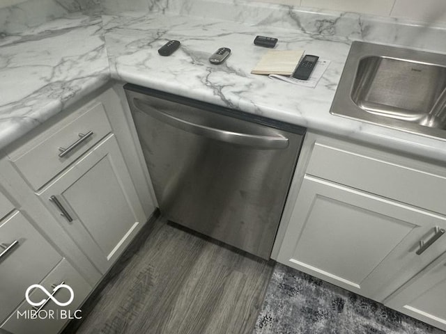 1306 Woodbine Dr, Anderson, IN 46011 - kitchen view of stainless steel dishwasher, dark wood-type flooring, light countertops, and white cabinets