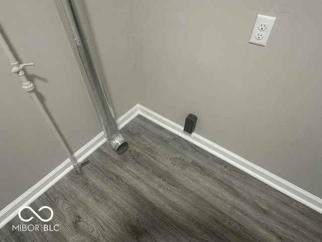 1306 Woodbine Dr, Anderson, IN 46011 - laundry room with dark wood-type flooring and baseboards
