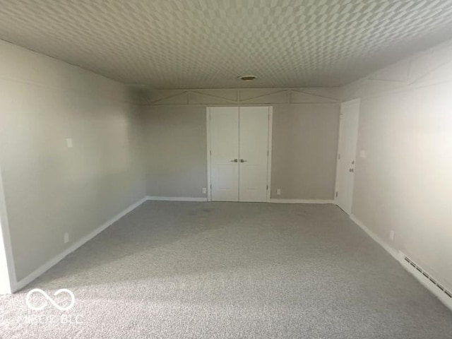 1306 Woodbine Dr, Anderson, IN 46011 - carpeted empty room featuring baseboards and a baseboard heating unit