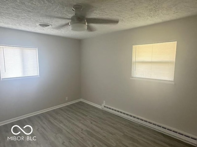 1306 Woodbine Dr, Anderson, IN 46011 - spare room with a baseboard heating unit, wood finished floors, a textured ceiling, and a ceiling fan