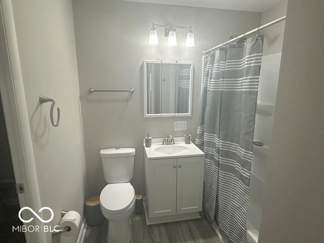 1306 Woodbine Dr, Anderson, IN 46011 - full bathroom with vanity, wood finished floors, and a shower with shower curtain