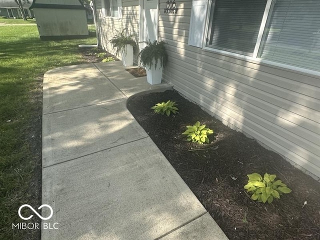 1306 Woodbine Dr, Anderson, IN 46011 - view of home's exterior with a patio area and a yard