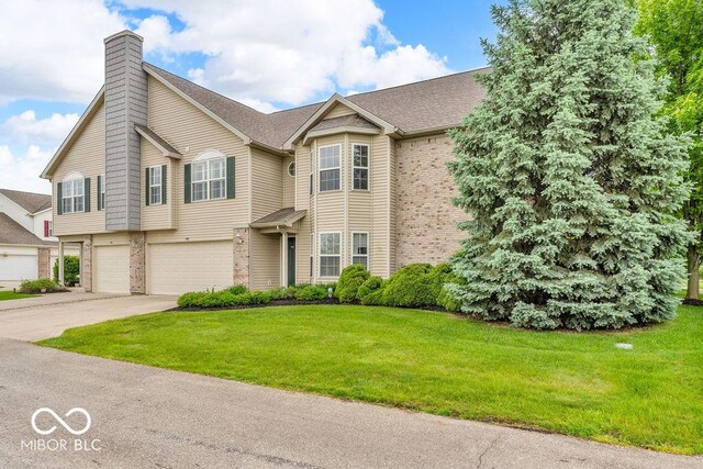 1139 Fernwood Way, Plainfield, IN 46168 - view of front of home with brick siding, an attached garage, a chimney, concrete driveway, and a front lawn
