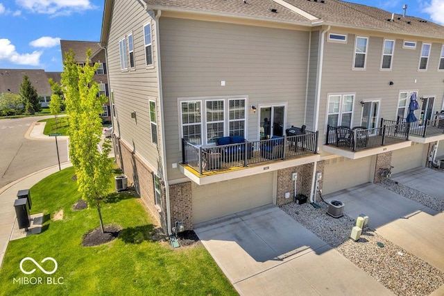 3546 Brampton Ln, Westfield, IN 46074 - back of property featuring an attached garage, driveway, and brick siding