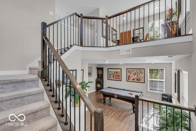 3546 Brampton Ln, Westfield, IN 46074 - stairway featuring wood finished floors, a towering ceiling, and billiards