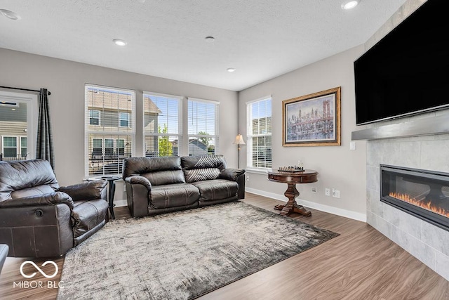 3546 Brampton Ln, Westfield, IN 46074 - living area featuring wood finished floors, a fireplace, a textured ceiling, and recessed lighting