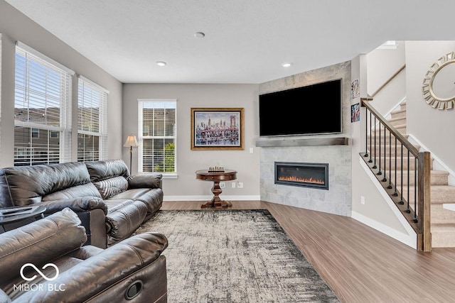 3546 Brampton Ln, Westfield, IN 46074 - living area with wood finished floors, stairway, a fireplace, and recessed lighting