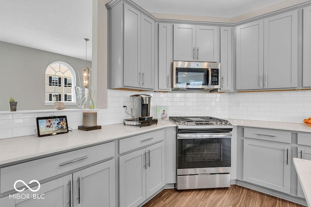 3546 Brampton Ln, Westfield, IN 46074 - kitchen featuring appliances with stainless steel finishes, gray cabinets, light countertops, and backsplash