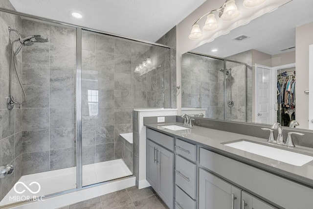 3546 Brampton Ln, Westfield, IN 46074 - bathroom with a stall shower, double vanity, a spacious closet, tile patterned floors, and recessed lighting