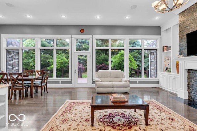 720 Willow Pointe N Dr, Plainfield, IN 46168 - living room with a fireplace with flush hearth, recessed lighting, plenty of natural light, built in features, and a chandelier