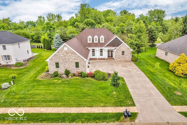 720 Willow Pointe N Dr, Plainfield, IN 46168 - traditional-style house with concrete driveway, brick siding, stone siding, and a front yard