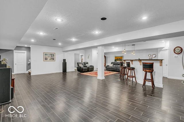720 Willow Pointe N Dr, Plainfield, IN 46168 - living area with a textured ceiling, bar area, recessed lighting, dark wood-style floors, and stairs
