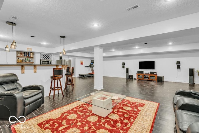 720 Willow Pointe N Dr, Plainfield, IN 46168 - living area featuring a textured ceiling, dark wood-style floors, recessed lighting, and bar