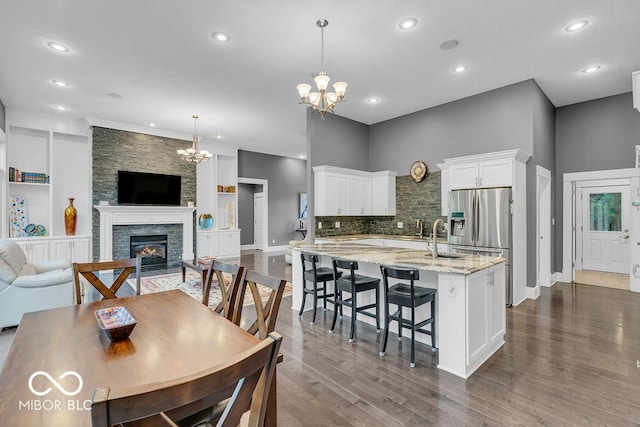 720 Willow Pointe N Dr, Plainfield, IN 46168 - dining room featuring a chandelier, dark wood-type flooring, a fireplace, and recessed lighting