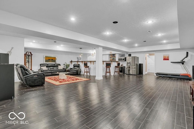720 Willow Pointe N Dr, Plainfield, IN 46168 - living area featuring a textured ceiling, dark wood-style flooring, a tray ceiling, and recessed lighting