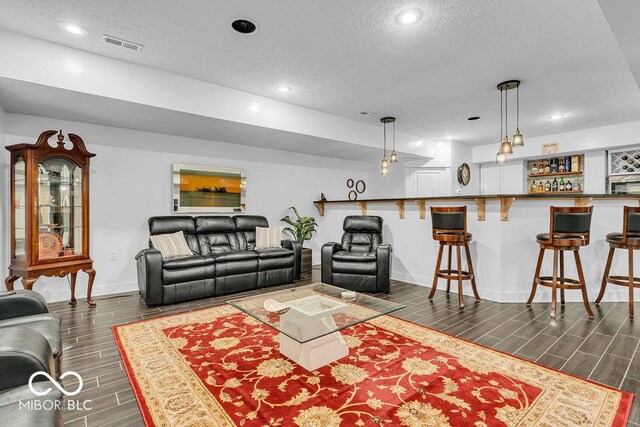 720 Willow Pointe N Dr, Plainfield, IN 46168 - living area with a textured ceiling, wood finish floors, bar, and recessed lighting
