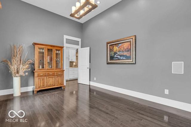 720 Willow Pointe N Dr, Plainfield, IN 46168 - unfurnished room featuring a towering ceiling, dark wood-style flooring, and a chandelier