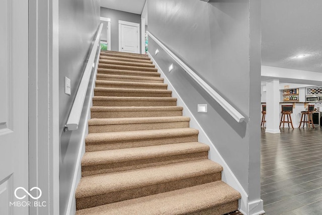 720 Willow Pointe N Dr, Plainfield, IN 46168 - stairway featuring bar area and wood finished floors