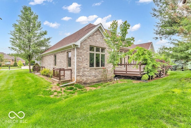 720 Willow Pointe N Dr, Plainfield, IN 46168 - back of property featuring a deck, a yard, brick siding, and a shingled roof