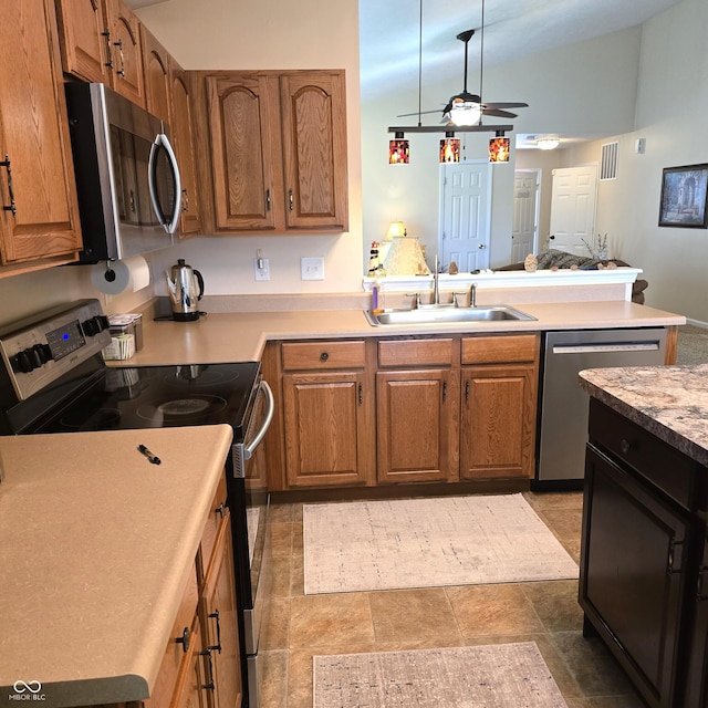 7608 Mather Ln, Indianapolis, IN 46239 - kitchen featuring appliances with stainless steel finishes, ceiling fan, brown cabinets, and light countertops