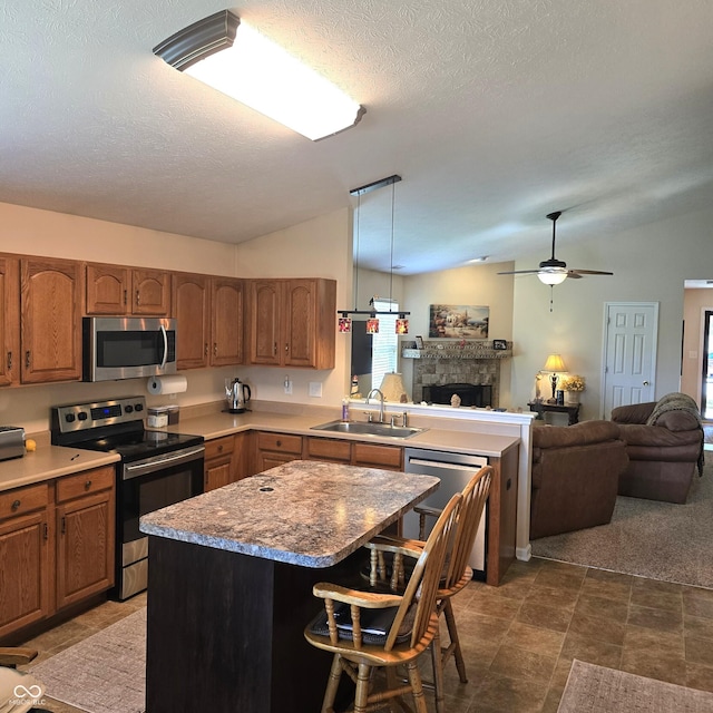 7608 Mather Ln, Indianapolis, IN 46239 - kitchen featuring appliances with stainless steel finishes, lofted ceiling, open floor plan, a peninsula, and a kitchen breakfast bar