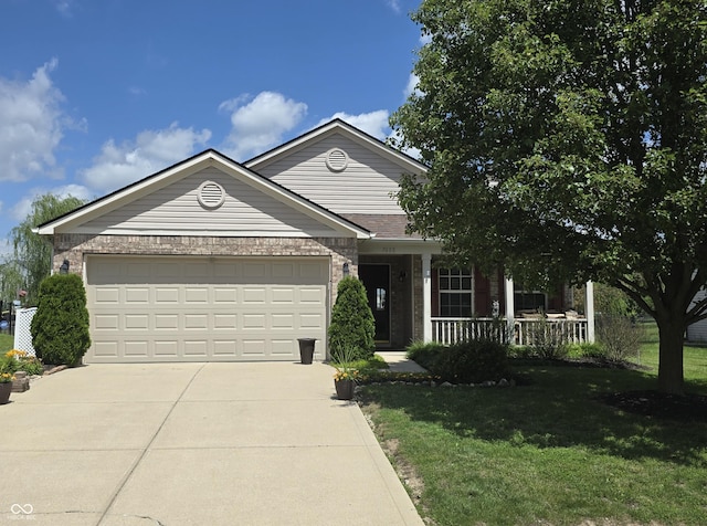 7608 Mather Ln, Indianapolis, IN 46239 - view of front of house with a porch, concrete driveway, a front lawn, an attached garage, and brick siding