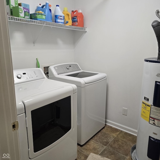 7608 Mather Ln, Indianapolis, IN 46239 - laundry room featuring electric water heater, washing machine and dryer, and dark stone finish flooring