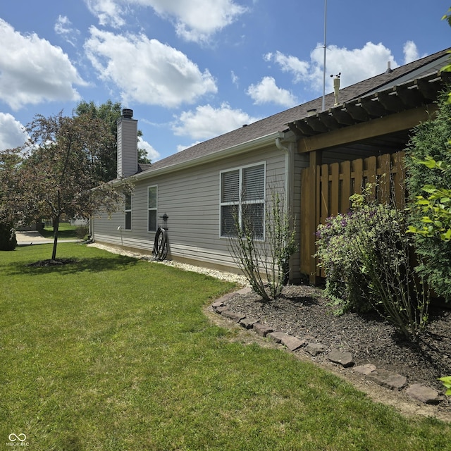 7608 Mather Ln, Indianapolis, IN 46239 - rear view of house featuring a yard and a chimney