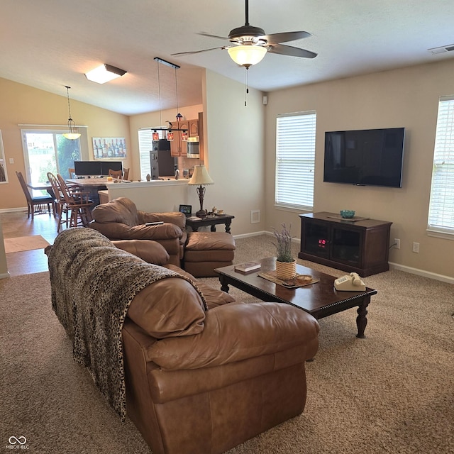 7608 Mather Ln, Indianapolis, IN 46239 - carpeted living area with plenty of natural light, ceiling fan, and vaulted ceiling
