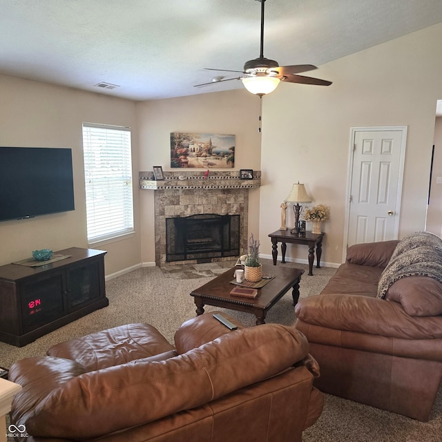 7608 Mather Ln, Indianapolis, IN 46239 - carpeted living room featuring a stone fireplace, a ceiling fan, and lofted ceiling