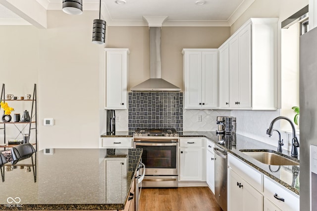 830 Freeland Way, Carmel, IN 46032 - kitchen with appliances with stainless steel finishes, wall chimney exhaust hood, white cabinets, dark stone counters, and ornamental molding
