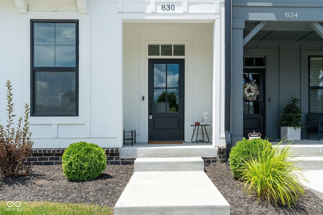 830 Freeland Way, Carmel, IN 46032 - view of exterior entry with board and batten siding and a porch