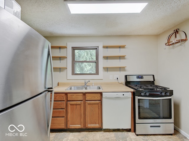 1908 W Northgate St, Indianapolis, IN 46228 - kitchen featuring stainless steel appliances, open shelves, a textured ceiling, brown cabinets, and light countertops