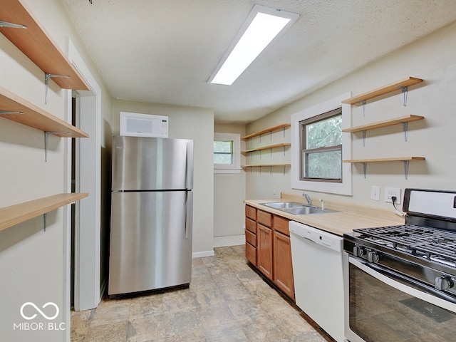 1908 W Northgate St, Indianapolis, IN 46228 - kitchen with open shelves, stainless steel appliances, light countertops, stone finish flooring, and brown cabinets