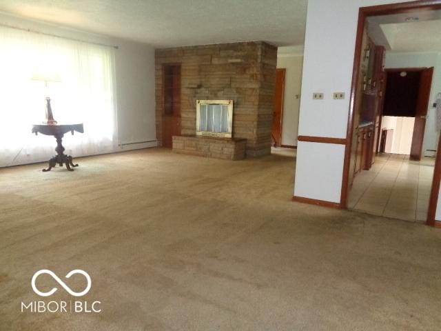 3253 W 34th St, Indianapolis, IN 46222 - unfurnished living room featuring carpet floors and a large fireplace